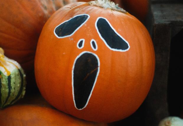 A frightened face is painted on the pumpkin